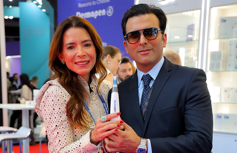 Dr Bilal Malik demonstrating Dermapen device with aesthetic professional at AMWC Monaco