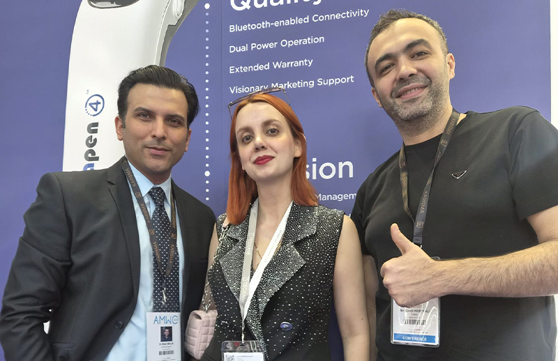 Dr Bilal Malik taking photo with professionals at AMWC Monaco conference