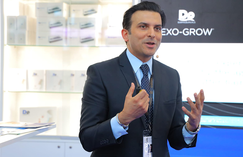 Dr Bilal Malik explaining treatment techniques to audience at AMWC Monaco