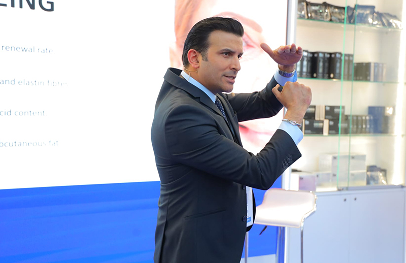 Dr Bilal Malik explaining aesthetic techniques at DermapenWorld booth AMWC Monaco