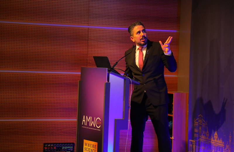Dr Bilal Malik presenting aesthetic concepts on stage at AMWC Monaco